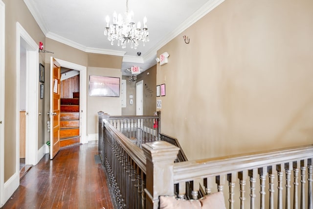 hallway featuring an inviting chandelier, crown molding, and dark hardwood / wood-style floors