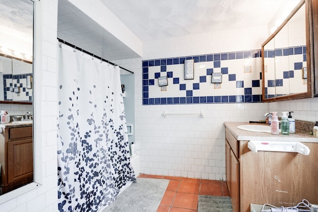 bathroom featuring tile walls, tile patterned floors, vanity, and shower / tub combo with curtain