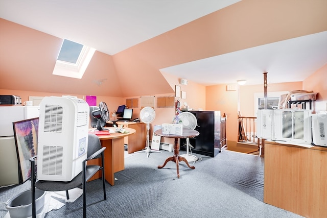 carpeted home office featuring lofted ceiling with skylight