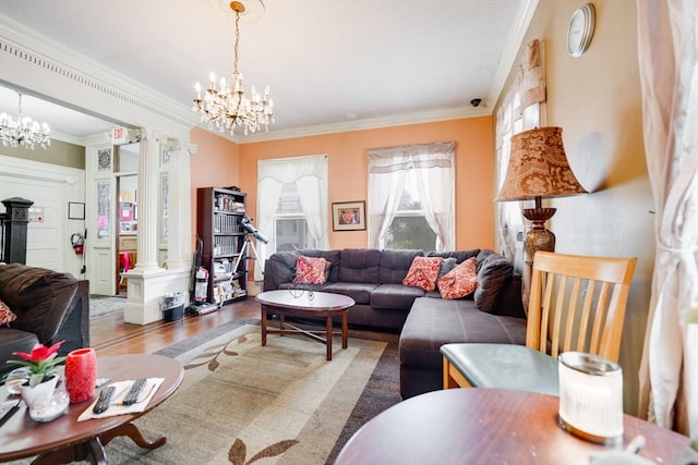 living room with crown molding, a chandelier, ornate columns, and dark hardwood / wood-style floors