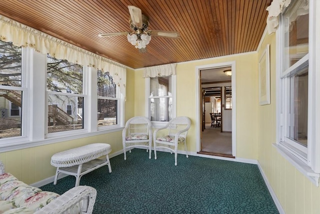 sunroom / solarium with wooden ceiling and ceiling fan