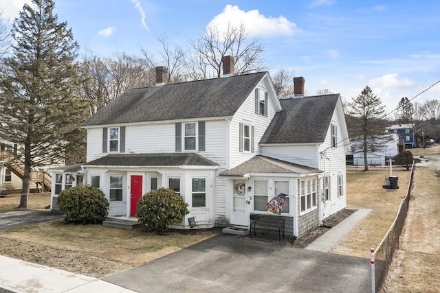 view of front of property featuring roof with shingles and a chimney