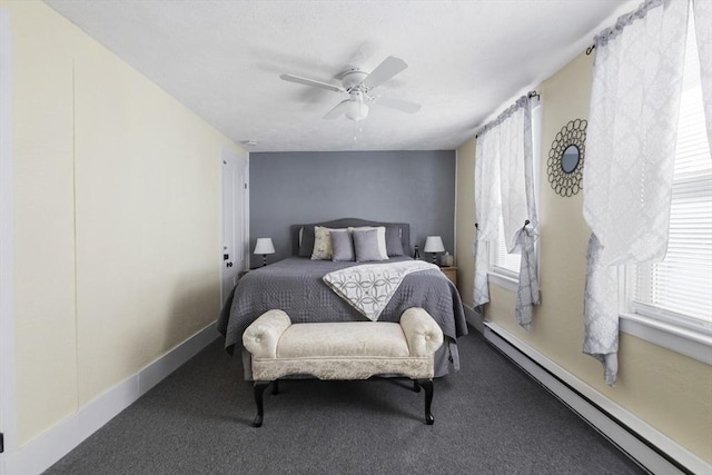 carpeted bedroom with a baseboard radiator, multiple windows, baseboards, and ceiling fan