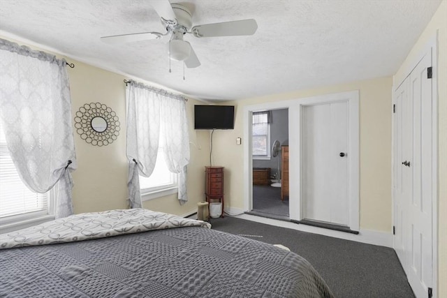 bedroom featuring a ceiling fan, carpet, baseboards, and a textured ceiling