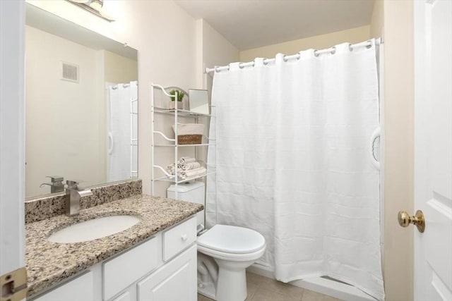 bathroom featuring a shower with curtain, vanity, toilet, and tile patterned flooring