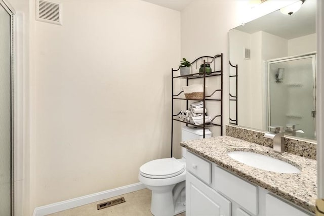 bathroom with vanity, tile patterned floors, toilet, and walk in shower