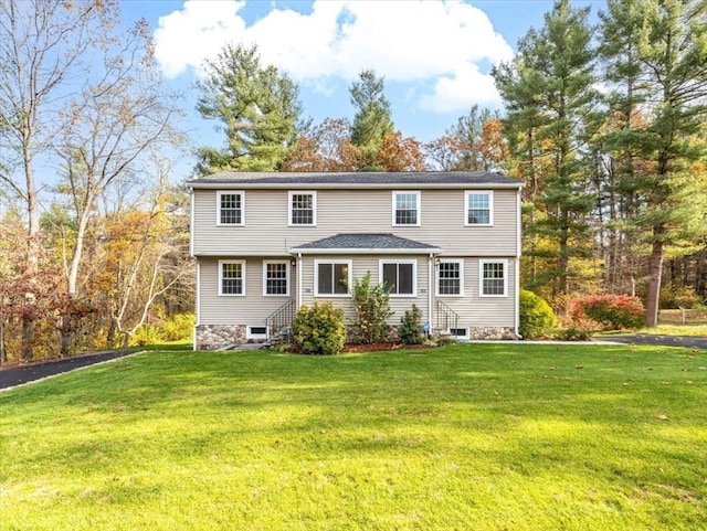 rear view of house featuring a lawn