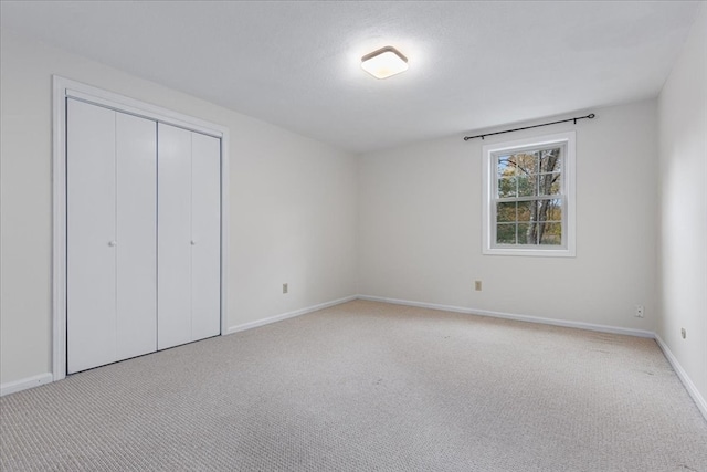 unfurnished bedroom featuring light colored carpet