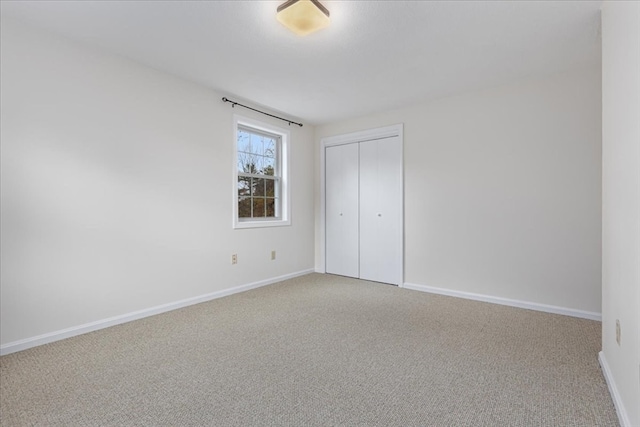 unfurnished bedroom with a closet and carpet floors