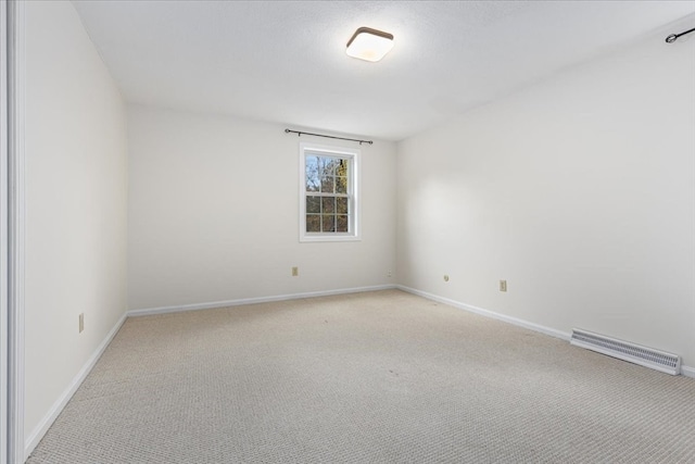 spare room with light colored carpet