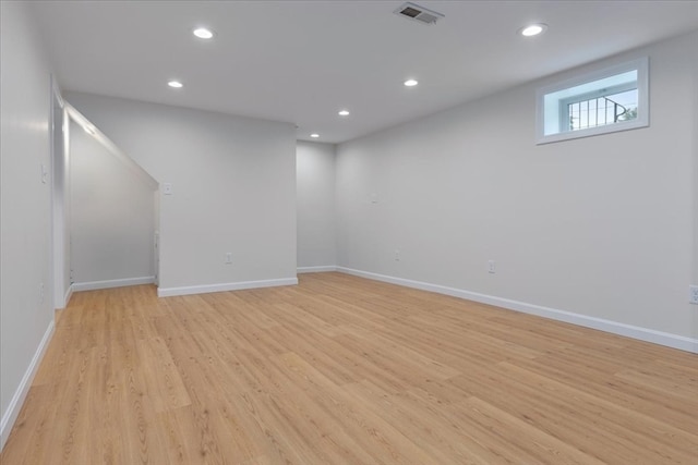 basement with light hardwood / wood-style flooring