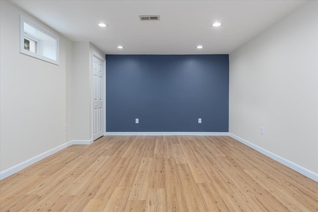 empty room with light hardwood / wood-style flooring