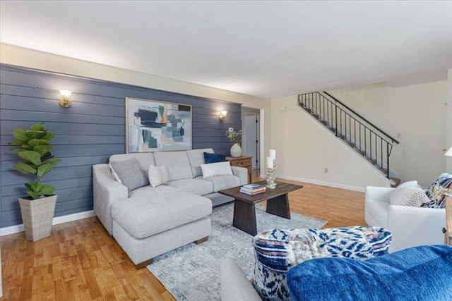 living room featuring hardwood / wood-style floors and wooden walls