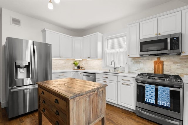 kitchen featuring dark hardwood / wood-style flooring, sink, white cabinets, and appliances with stainless steel finishes