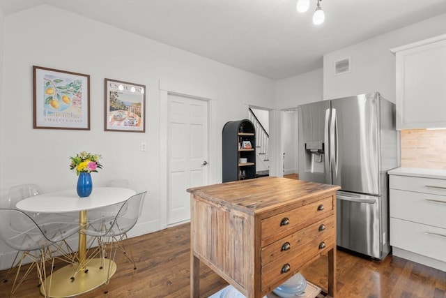 kitchen featuring white cabinetry, dark wood-type flooring, and stainless steel fridge with ice dispenser