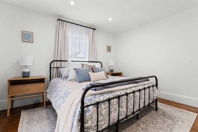 bedroom with dark hardwood / wood-style floors