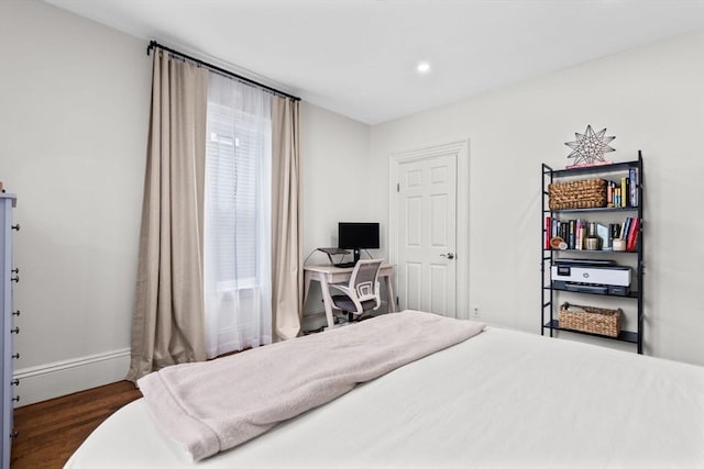 bedroom featuring dark wood-type flooring and multiple windows