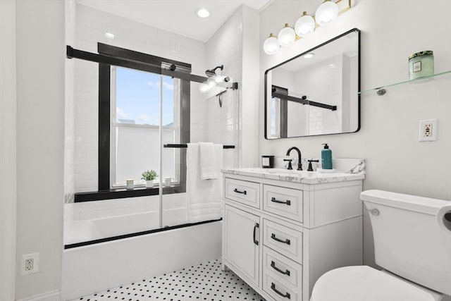 full bathroom featuring vanity, toilet, and combined bath / shower with glass door