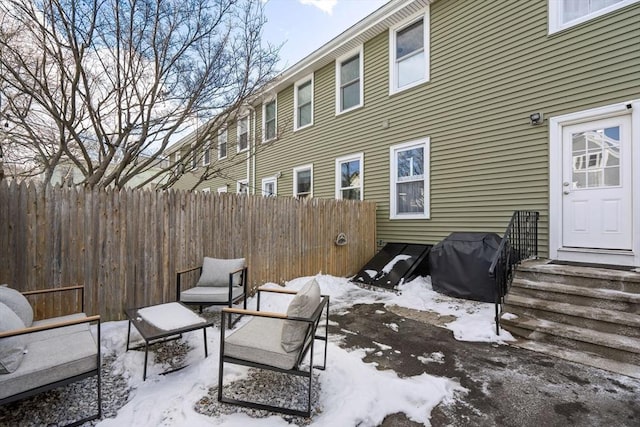 snow covered patio featuring a grill