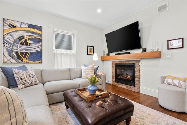 living room with a fireplace and dark wood-type flooring