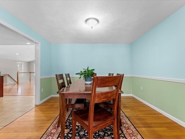 dining room featuring wood finished floors and baseboards