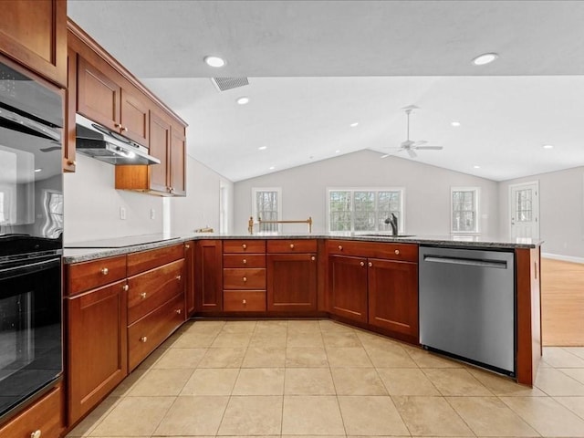 kitchen featuring lofted ceiling, under cabinet range hood, black appliances, a sink, and light tile patterned flooring