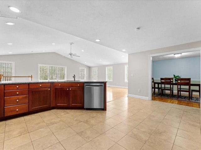 kitchen featuring vaulted ceiling, a healthy amount of sunlight, a sink, and stainless steel dishwasher