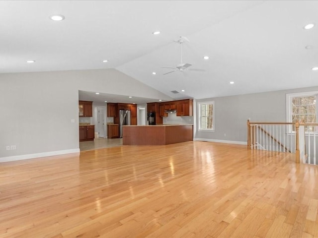 unfurnished living room featuring lofted ceiling, recessed lighting, light wood-style floors, a ceiling fan, and baseboards