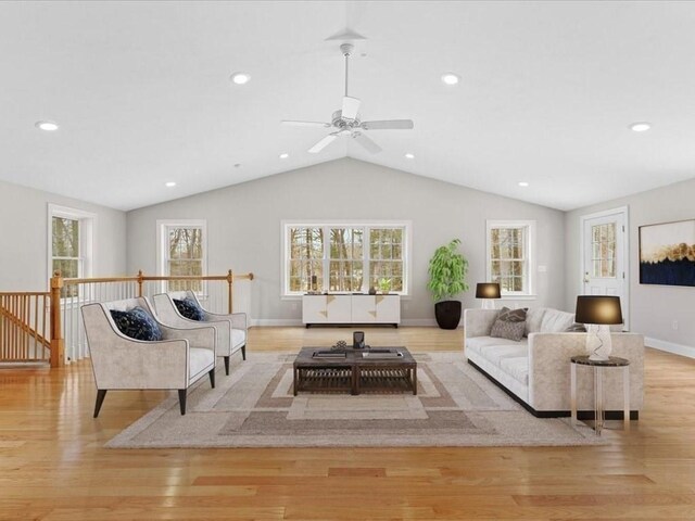 living room with lofted ceiling, baseboards, light wood finished floors, and recessed lighting