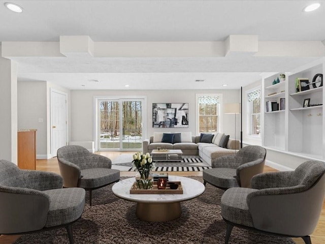 living room with baseboards, recessed lighting, and light wood-style floors