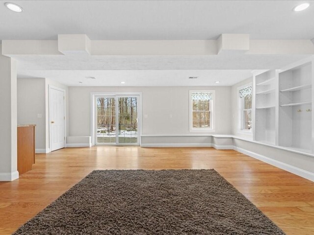 empty room with recessed lighting, light wood-style flooring, and baseboards