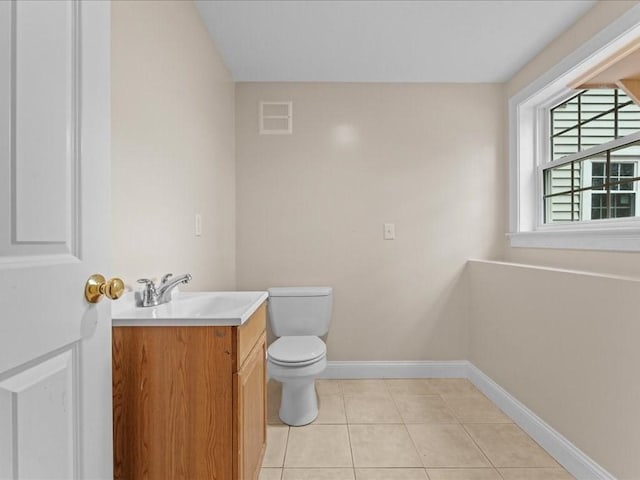 half bathroom featuring visible vents, baseboards, toilet, tile patterned flooring, and vanity