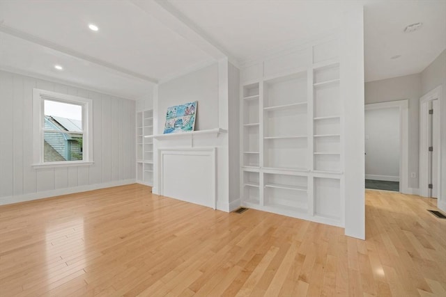 unfurnished living room with built in shelves and light hardwood / wood-style floors