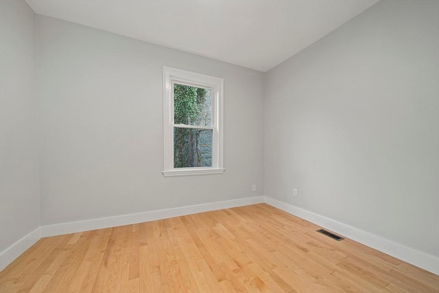 empty room with light hardwood / wood-style flooring