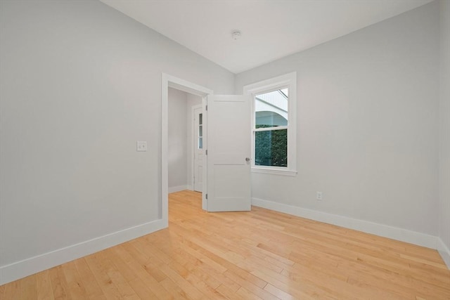 spare room with hardwood / wood-style floors