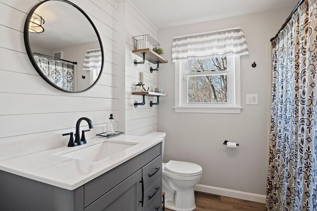 bathroom featuring vanity, wood-type flooring, and toilet