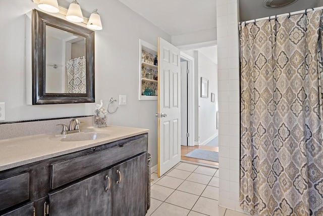 bathroom with vanity, curtained shower, and tile patterned floors