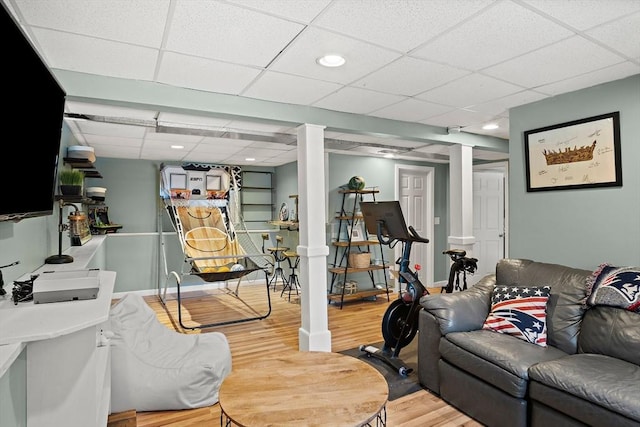 exercise room with wood-type flooring and a paneled ceiling