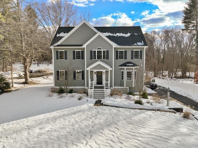 colonial-style house featuring fence