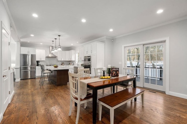 dining room with baseboards, ornamental molding, dark wood-type flooring, and recessed lighting