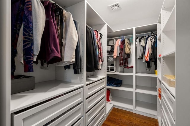 spacious closet with visible vents and dark wood finished floors