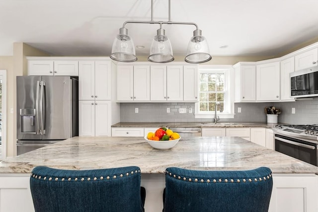 kitchen featuring stainless steel appliances, tasteful backsplash, a sink, and light stone counters