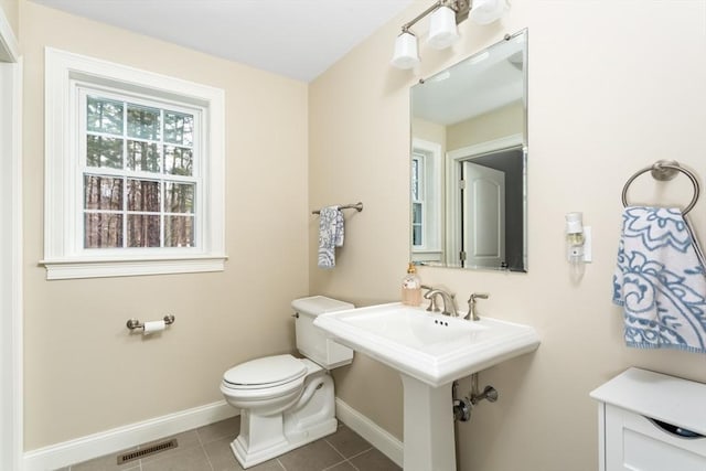 bathroom with tile patterned flooring, baseboards, visible vents, and toilet