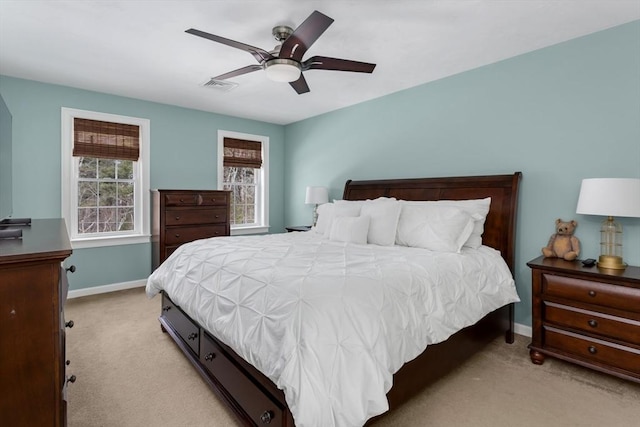 bedroom featuring baseboards, a ceiling fan, and light colored carpet