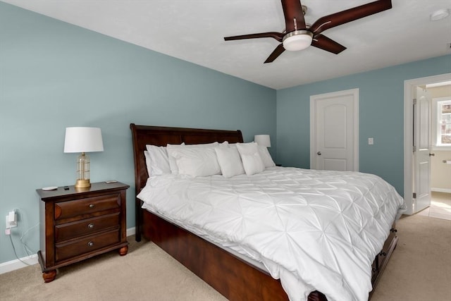 carpeted bedroom featuring ceiling fan and baseboards