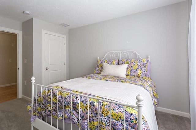 carpeted bedroom featuring baseboards and visible vents