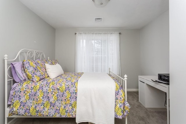 carpeted bedroom with visible vents and baseboards