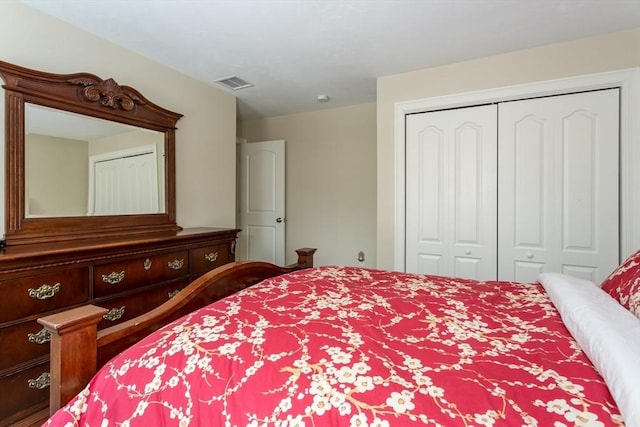 bedroom with a closet and visible vents