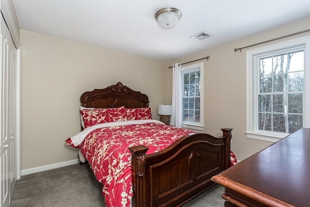 bedroom featuring carpet, multiple windows, visible vents, and baseboards