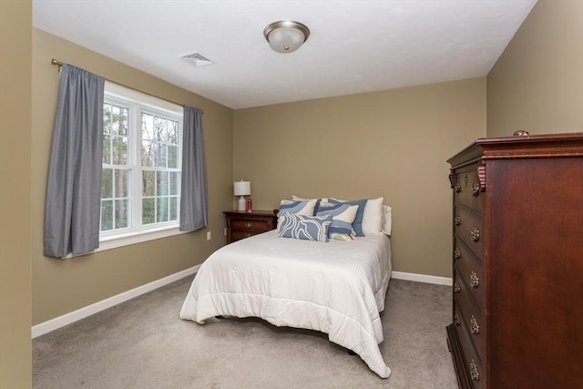 bedroom with baseboards, visible vents, and carpet flooring